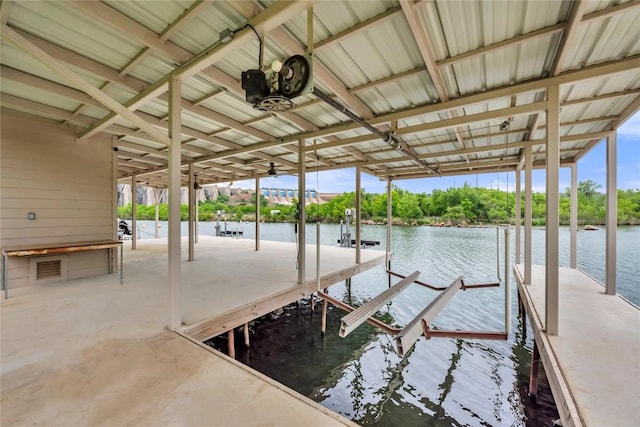 dock area with a water view and boat lift