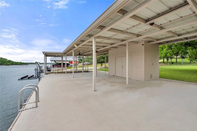 exterior space with a water view, a boat dock, and boat lift