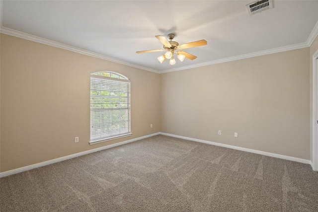 empty room with crown molding, carpet flooring, a ceiling fan, and visible vents