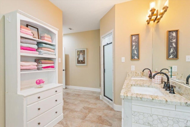 160 Buccaneer Way, Waco, TX 76638 - bathroom featuring a stall shower, baseboards, and double vanity
