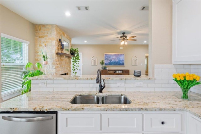 160 Buccaneer Way, Waco, TX 76638 - kitchen featuring a sink, dishwasher, tasteful backsplash, a ceiling fan, and white cabinetry