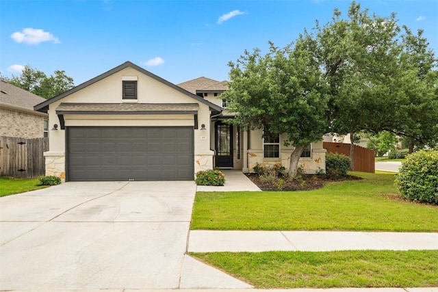view of front of house with fence, stone siding, driveway, a garage, and stucco siding