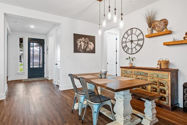 dining space with baseboards and dark wood-type flooring