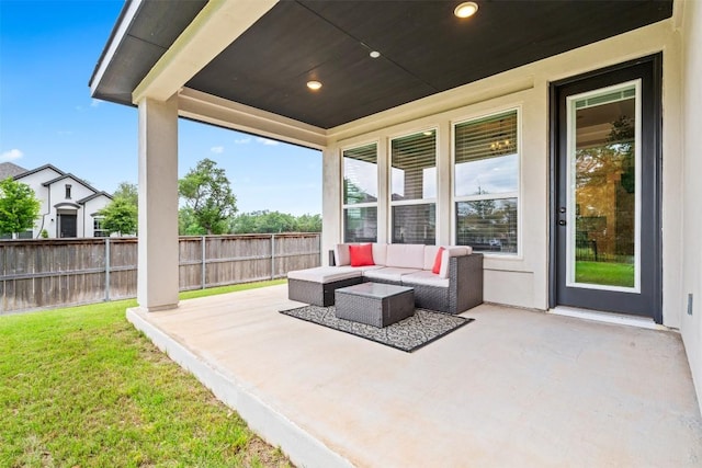 view of patio with an outdoor living space and fence