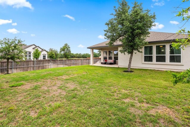 view of yard featuring fence and a patio