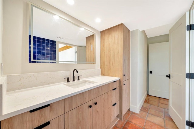 bathroom with visible vents, baseboards, vanity, and recessed lighting