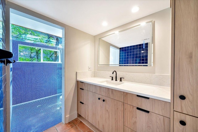 bathroom featuring tile patterned flooring and vanity