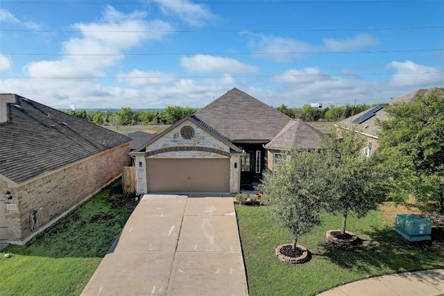 french provincial home with brick siding, concrete driveway, a garage, a front yard, and a shingled roof