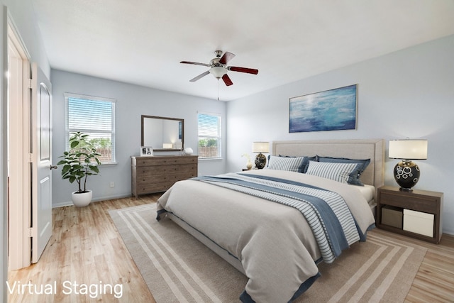 bedroom featuring baseboards, ceiling fan, and light wood-type flooring