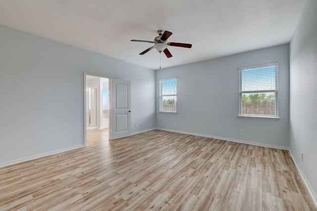 empty room featuring baseboards, light wood-style floors, and ceiling fan