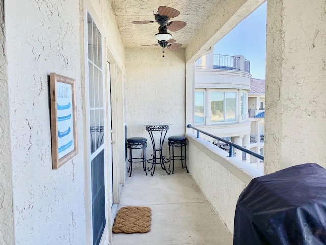 balcony featuring a ceiling fan