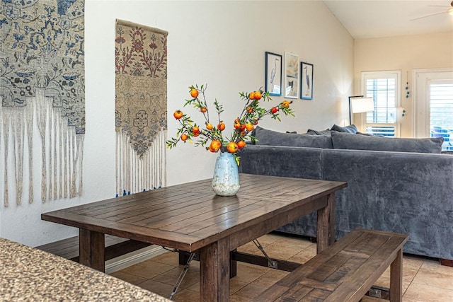 dining space with ceiling fan and light tile patterned floors