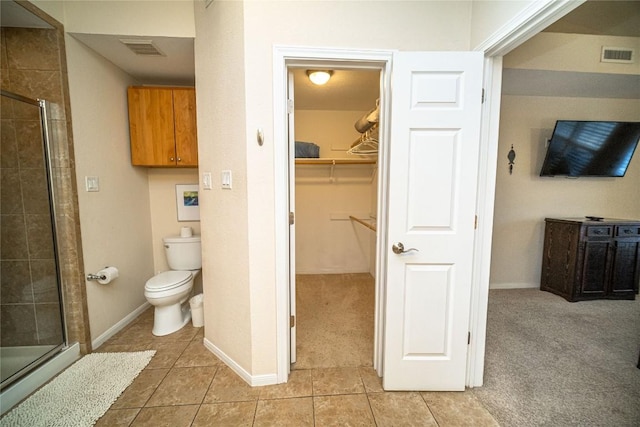 full bath with tile patterned floors, visible vents, and a shower stall