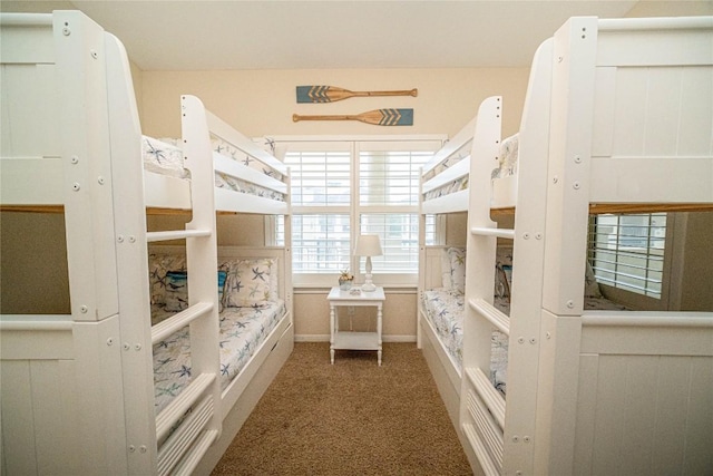 carpeted bedroom featuring baseboards