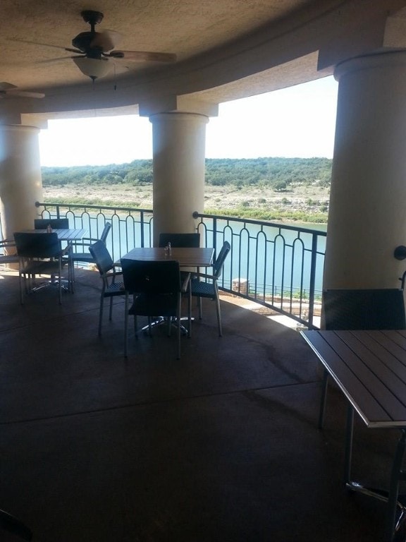 balcony with outdoor dining space and a ceiling fan