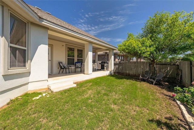 view of yard featuring a porch and fence