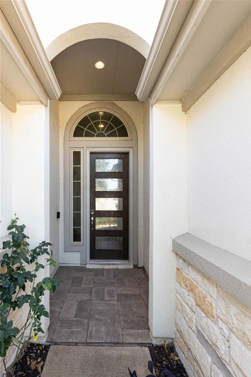 property entrance with stucco siding