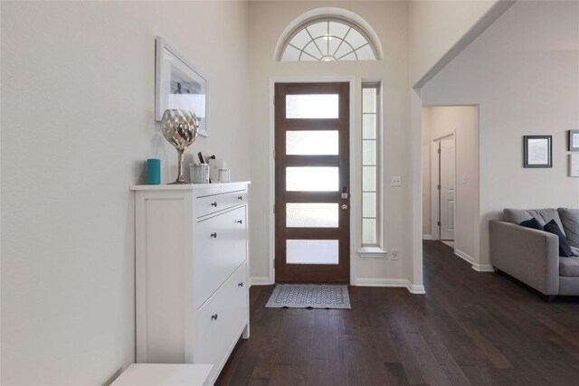 foyer entrance featuring wood finished floors and baseboards
