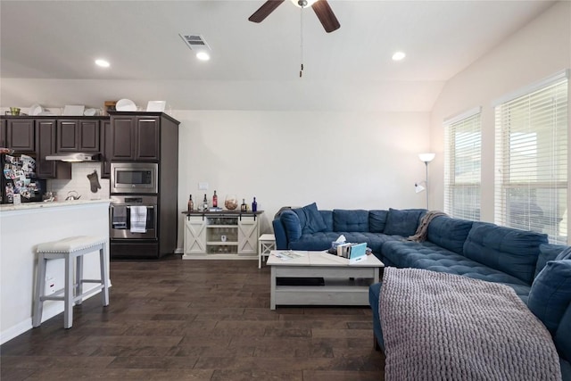 living room featuring lofted ceiling, recessed lighting, visible vents, ceiling fan, and dark wood-style floors