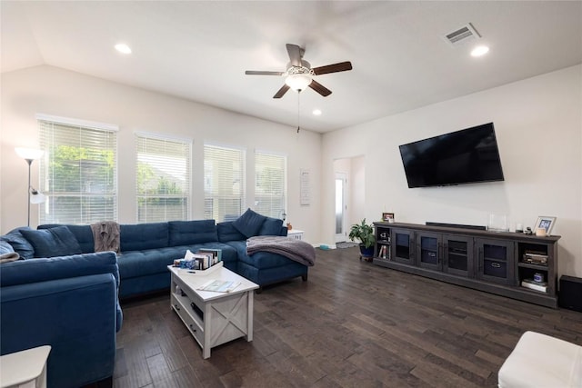 living area featuring lofted ceiling, visible vents, recessed lighting, dark wood finished floors, and a ceiling fan