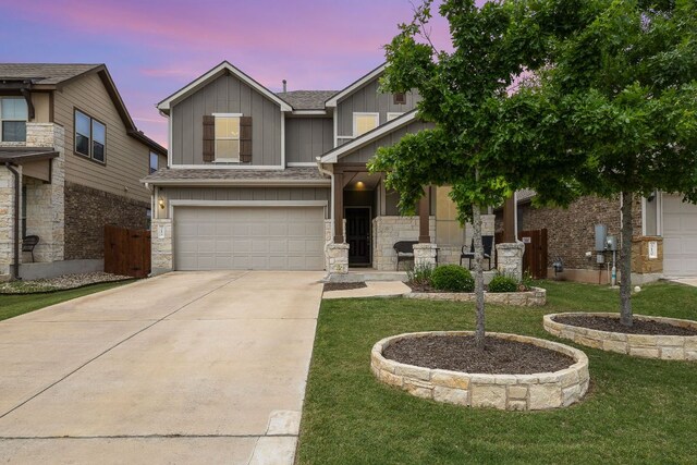 314 Andele Way, Liberty Hill, TX 78642 - view of front facade with a yard, concrete driveway, a garage, and board and batten siding