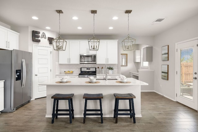 314 Andele Way, Liberty Hill, TX 78642 - kitchen with a sink, stainless steel appliances, visible vents, recessed lighting, and backsplash