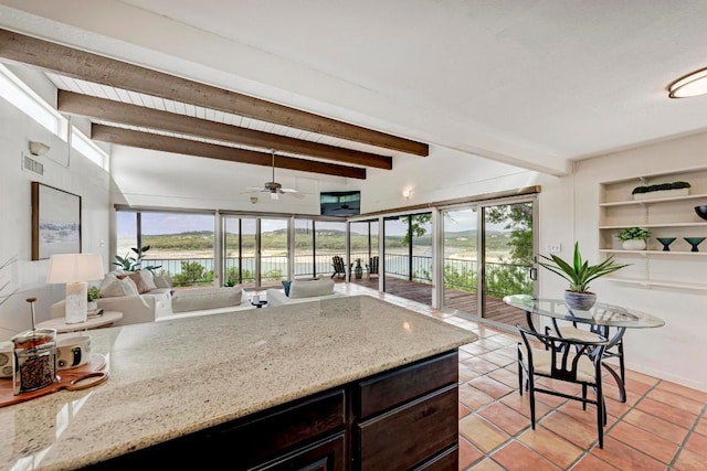 8130 Joy Rd, Volente, TX 78641 - kitchen featuring light tile patterned flooring, beamed ceiling, a ceiling fan, and a healthy amount of sunlight