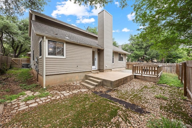13105 Lubbock Ln, Austin, TX 78729 - back of house with a chimney, a patio, and a fenced backyard
