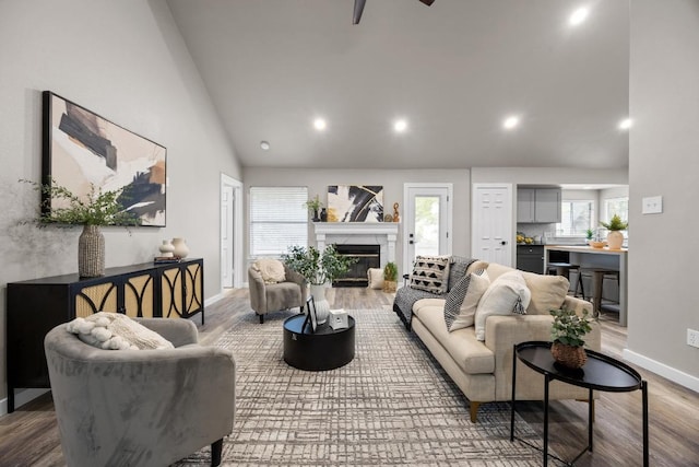 13105 Lubbock Ln, Austin, TX 78729 - living room with a high end fireplace, wood finished floors, recessed lighting, a ceiling fan, and high vaulted ceiling