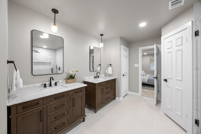 13105 Lubbock Ln, Austin, TX 78729 - full bath with two vanities, a marble finish shower, ensuite bathroom, and recessed lighting