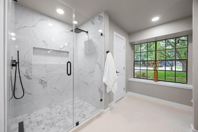 bathroom featuring a marble finish shower, baseboards, and recessed lighting