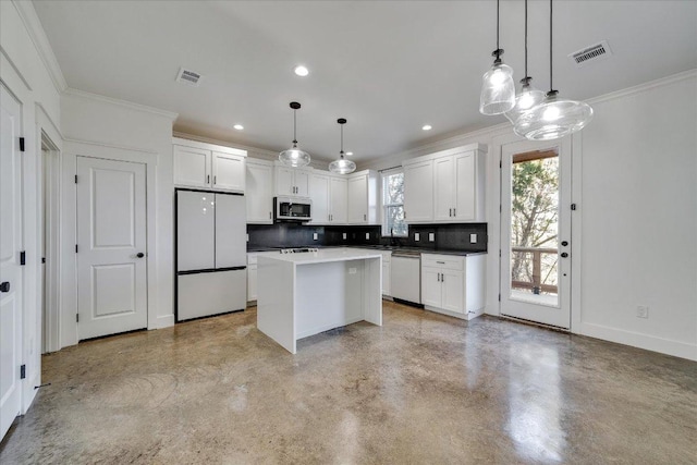 294 Shady Bluff Dr, Wimberley, TX 78676 - kitchen featuring freestanding refrigerator, dishwashing machine, ornamental molding, and visible vents