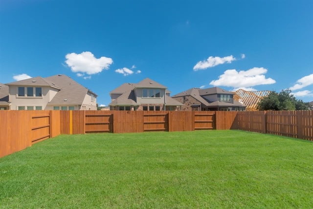 view of yard with a residential view and a fenced backyard