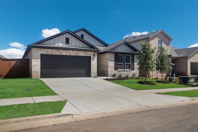 view of front of property with concrete driveway, a garage, brick siding, and board and batten siding