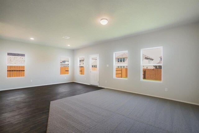 interior space featuring dark wood-style flooring, baseboards, and recessed lighting