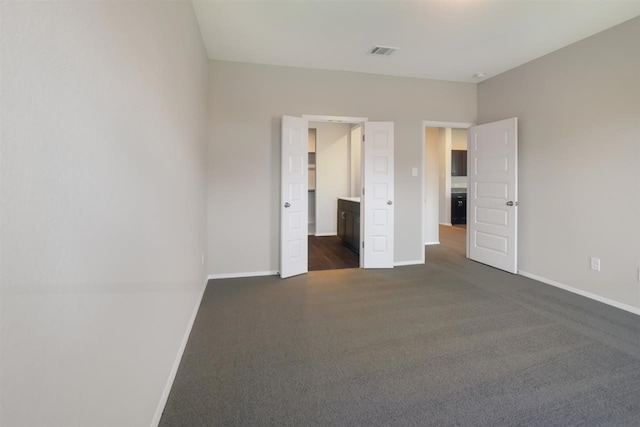 2428 Ambling Trl, Georgetown, TX 78628 - unfurnished bedroom featuring dark colored carpet and baseboards