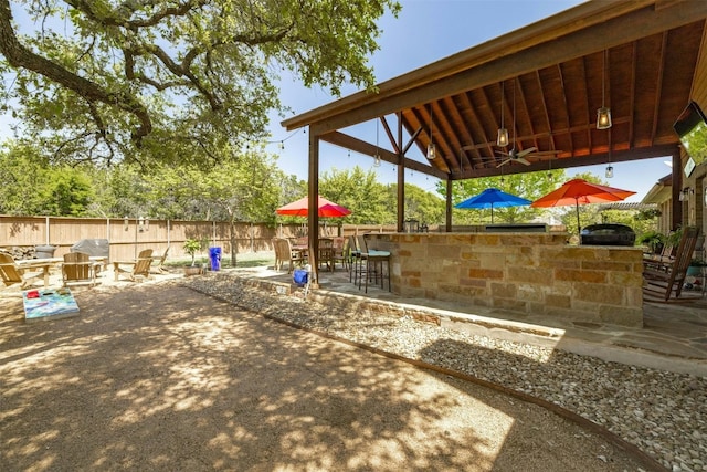 152 Florenz Ln, Georgetown, TX 78628 - exterior space with a ceiling fan, exterior bar, exterior kitchen, and fence