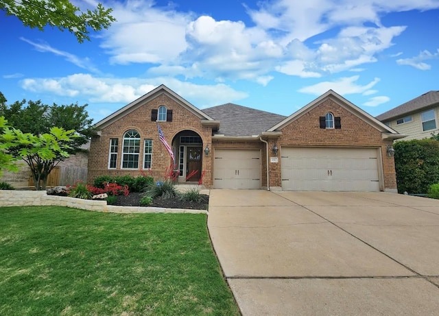 152 Florenz Ln, Georgetown, TX 78628 - single story home featuring driveway, brick siding, fence, an attached garage, and a front lawn