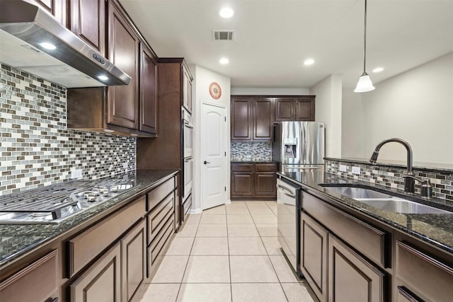 152 Florenz Ln, Georgetown, TX 78628 - kitchen with a sink, exhaust hood, decorative backsplash, and visible vents