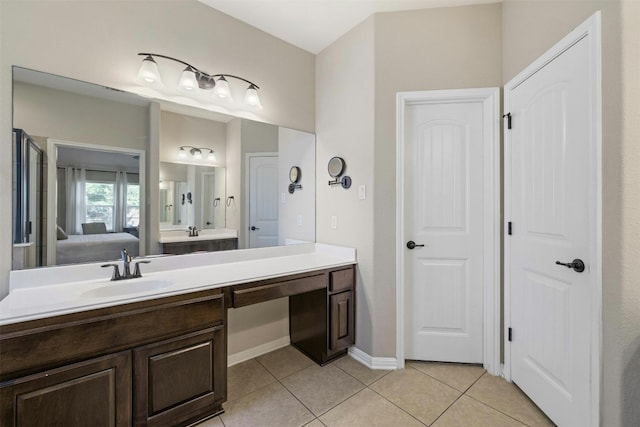 152 Florenz Ln, Georgetown, TX 78628 - ensuite bathroom with tile patterned flooring, connected bathroom, baseboards, and vanity