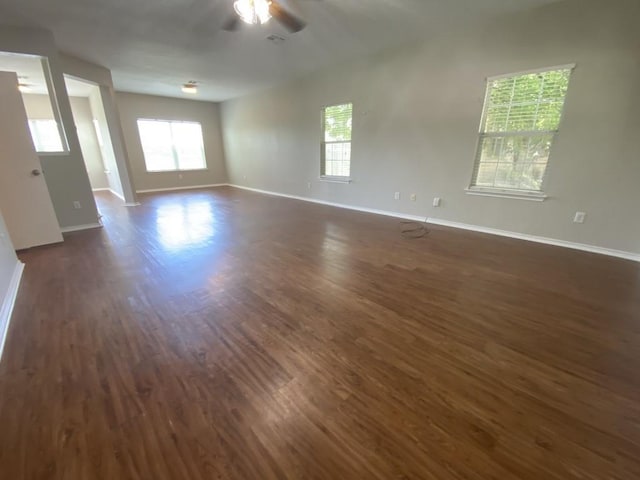 330 Mistletoe Ln, Kyle, TX 78640 - spare room with a wealth of natural light, dark wood-type flooring, baseboards, and a ceiling fan