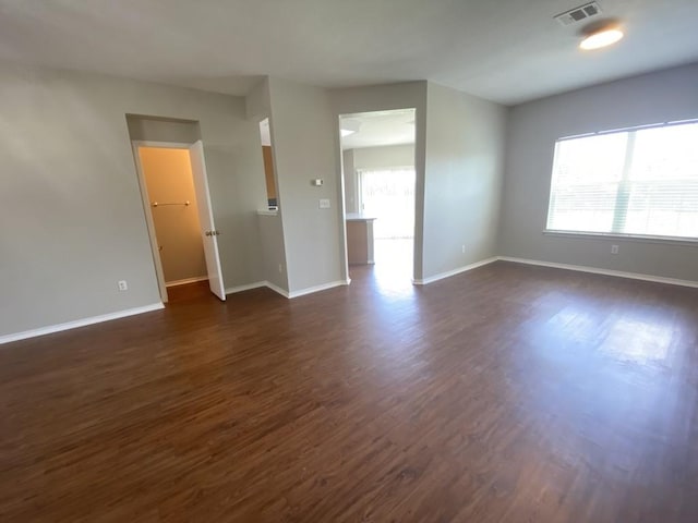 330 Mistletoe Ln, Kyle, TX 78640 - empty room featuring visible vents, baseboards, and dark wood-style floors