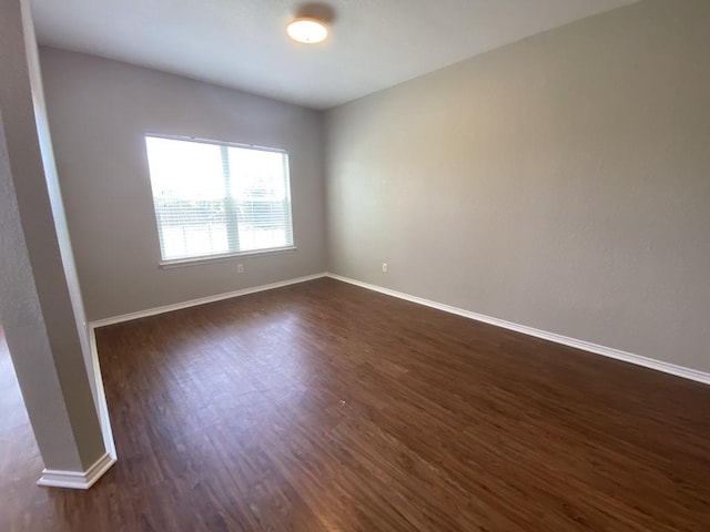 330 Mistletoe Ln, Kyle, TX 78640 - empty room with baseboards and dark wood-style floors
