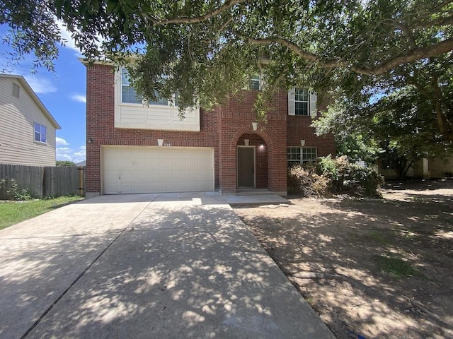 330 Mistletoe Ln, Kyle, TX 78640 - view of front of property with fence, concrete driveway, an attached garage, and brick siding