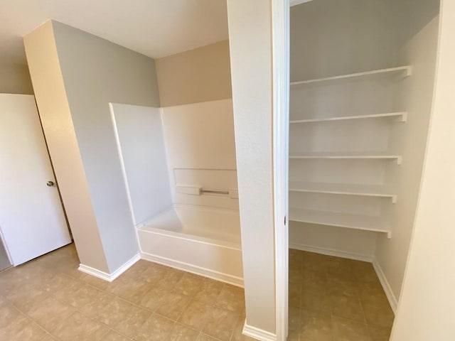 330 Mistletoe Ln, Kyle, TX 78640 - bathroom with tile patterned floors, a shower, baseboards, and a tub to relax in