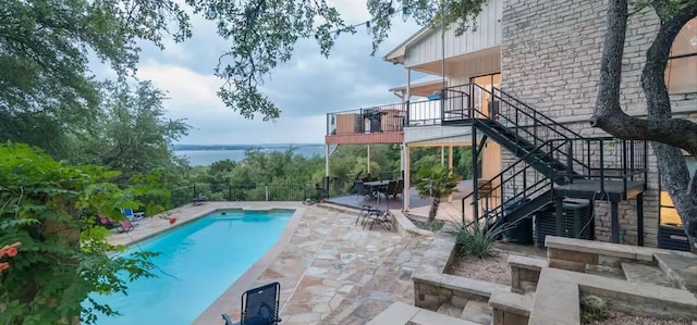 6714 Mtn Trl, Austin, TX 78732 - view of pool with stairs, a patio, and a water view