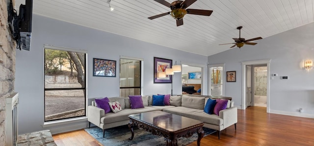 6714 Mtn Trl, Austin, TX 78732 - living area featuring ceiling fan, wood finished floors, vaulted ceiling, baseboards, and a fireplace