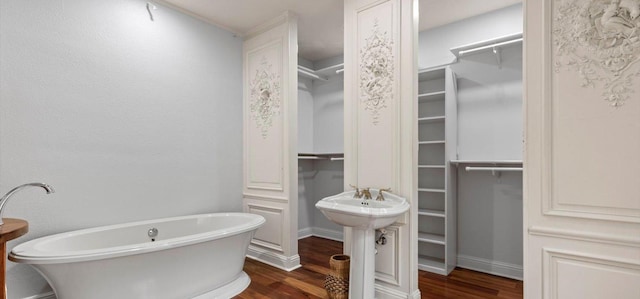 6714 Mtn Trl, Austin, TX 78732 - full bathroom featuring wood finished floors, a freestanding bath, and a spacious closet