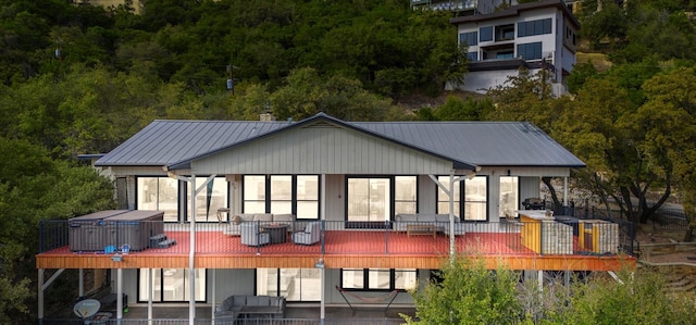 6714 Mtn Trl, Austin, TX 78732 - back of house featuring metal roof, a deck, and a patio area