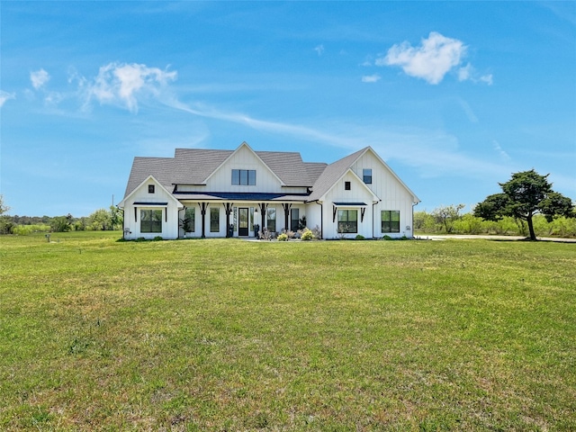 modern farmhouse style home with board and batten siding, a porch, and a front lawn